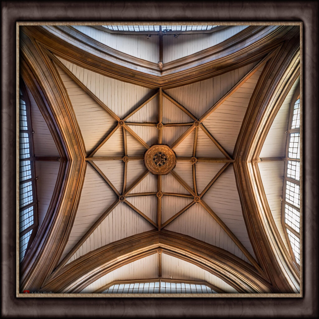 Description of cathedral ceilings with sloping sides that meet at a peak, creating a dramatic and open feeling in large spaces, often paired with large windows.